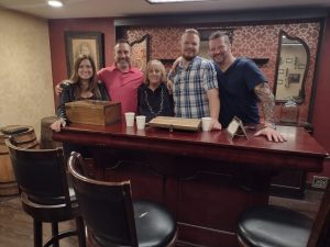 Work team posing inside a speakeasy themed escape room in Columbus Ohio